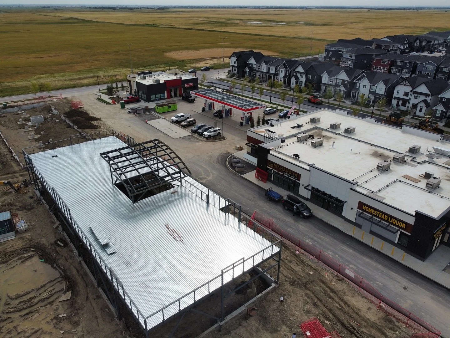 Aerial view of a commercial building under construction on Calgary's edge