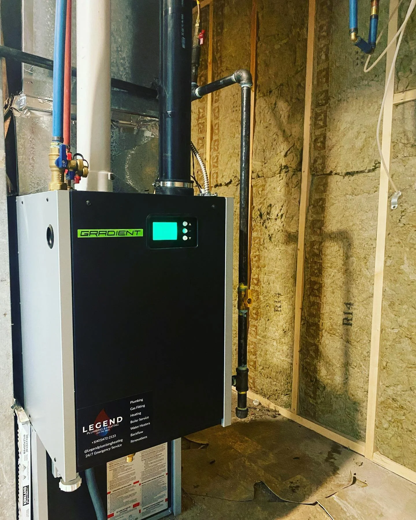 Condensing boiler installed to bare studs in an unfinished Calgary basement